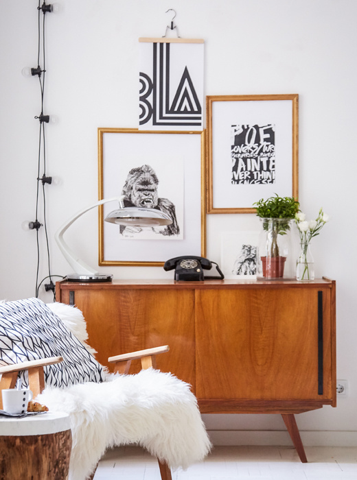 Black and white graphic artwork and vintage wooden furniture