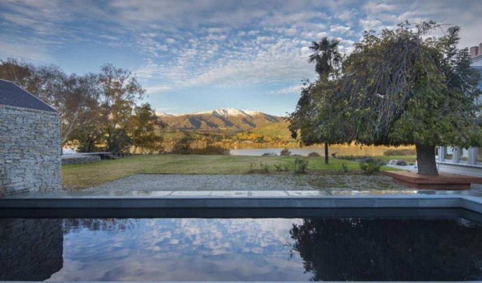 This historic heritage home is set on a large private estate with stylish contemporary interiors. The library at the front of the home looks onto manicured lawns, lush rose gardens and pristine Lake Hayes. Outdoors you'll find a swimming pool and dining area with fireplace.