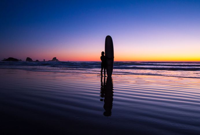 Indian Beach Surfer, Cannon Beach, Clatsop County, Oregon. This photo was featured to describe the rich experience of the Apple iPhone X screen at the keynote event in 2017.