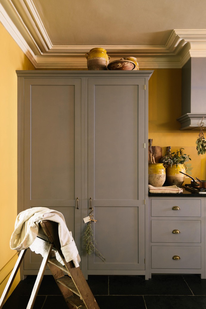 A full-sized Sub-Zero is hidden behind the left door of this tall cabinet. The door on the right conceals the larder.