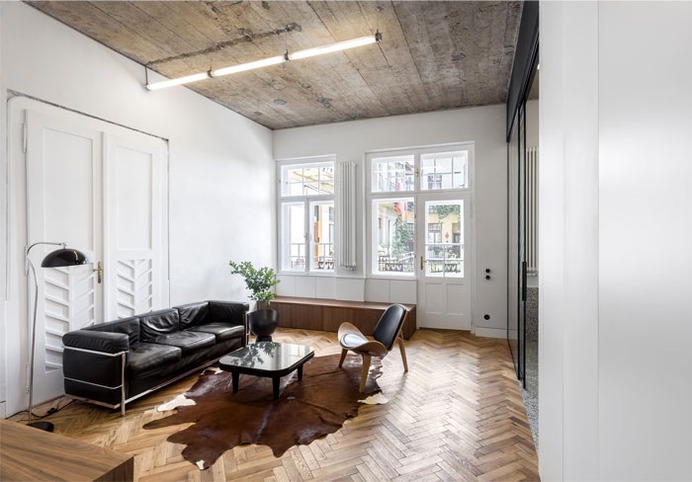 Trendy Terrazzo and Herringbone Parquet at Renovated Apartment by Alexandru Szűz Pop - InteriorZine