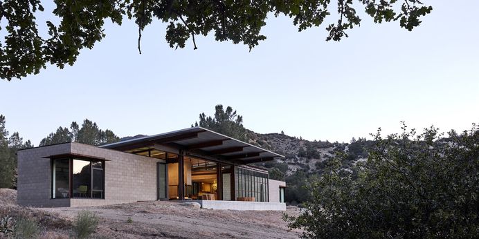 At This High-Desert Home, a Whole Wall Opens Up When You Crank a Giant Wheel #architecture #house #modern