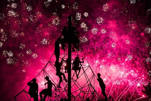 Kids staring the colorful fireworks on summertime.