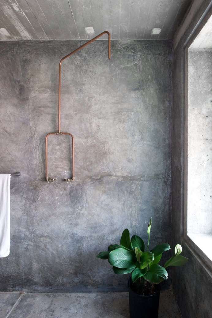 #Concrete #bathroom with exposed copper #pipeshower. Home of #WenHsiaAndBCAng. Photograph by #MarjonHoogervorst.