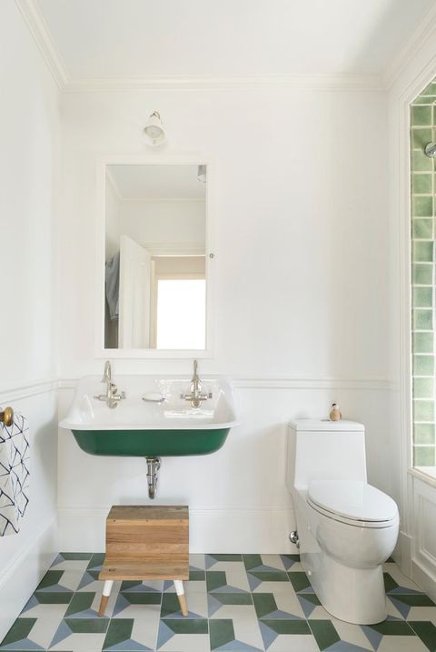 bathroom with green tiles and sink
