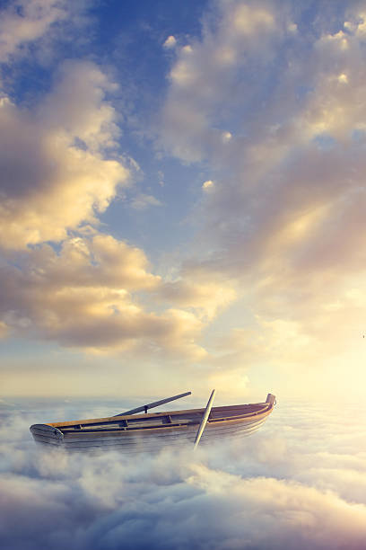Empty rowboat above clouds