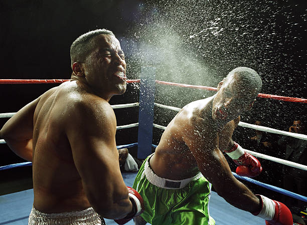 Heavyweight boxer landing right hook on opponent's jaw