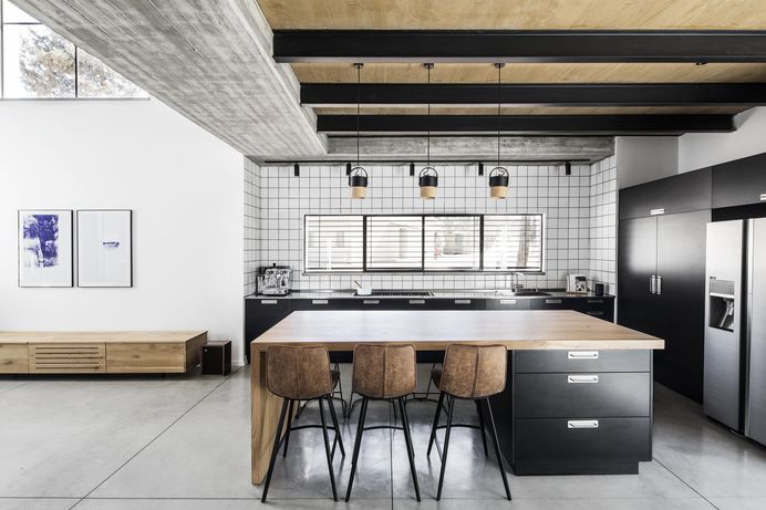Kitchen, Refrigerator, Cooktops, Dishwasher, Metal Counter, Colorful Cabinet, Concrete Floor, Ceramic Tile Backsplashe, Ceiling Lighting, Pendant Lighting, and Undermount Sink Photo 1 of 2509 in Best Kitchen Photos from Nir Am House