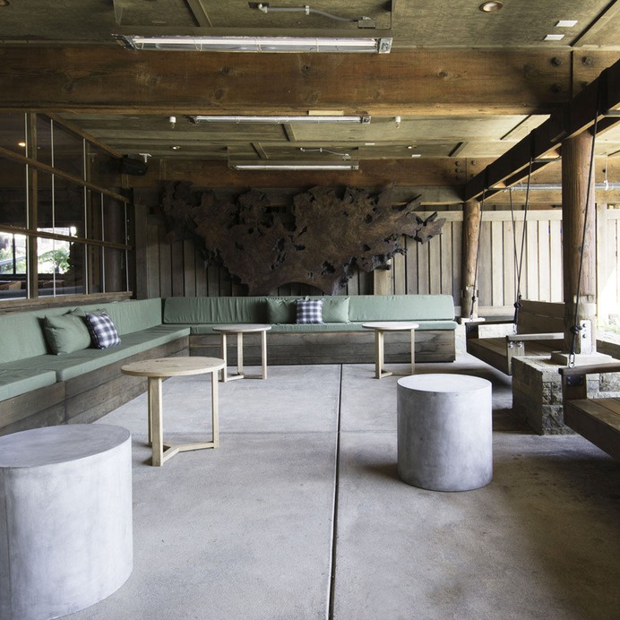 An outdoor "living room" has concrete floors and built-in seating.