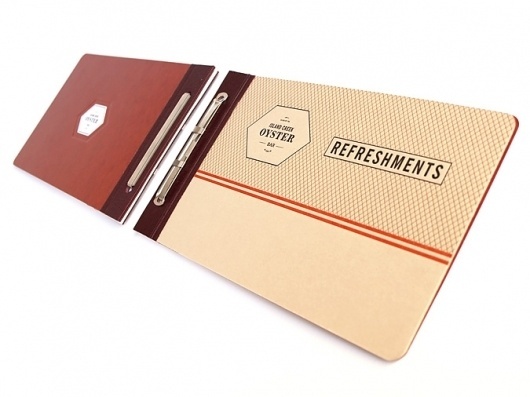 Art of the Menu: Island Creek Oyster Bar #maroon #ivory #menu #orange #black #crest #seal #collateral