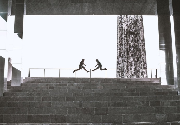 Two Person Jump Near Railings