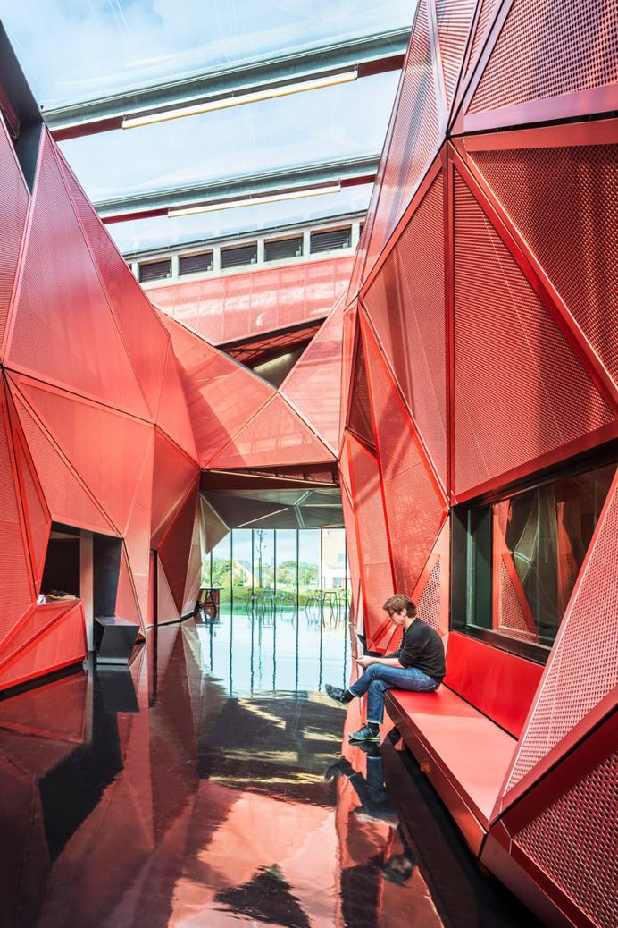 Faceted Red Metal Creates Sculptural Facade For Music Centre by Périphériques