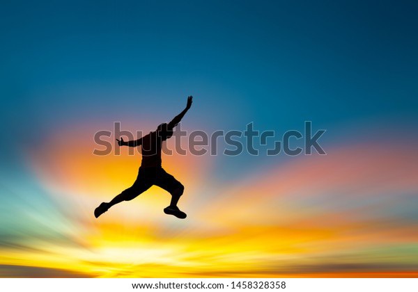 Happy man jumping At the time of the sun set Concept of vacation and travel