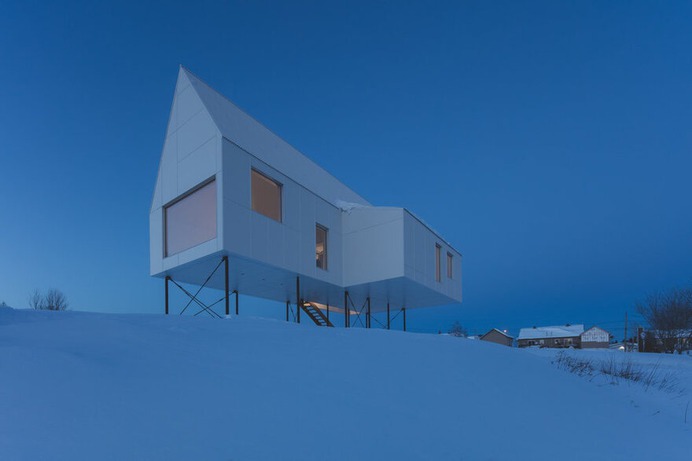 Winter Chalet on Stilts Rises Above a Snow-Laden Slope in Quebec