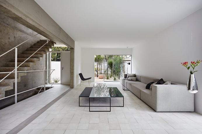 Living room with cantilevered concrete stairs. BN House by Metro Arquitetos Associados. Photo by Ilana Bessler. #bnhouse #livingroom