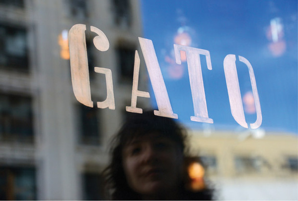 The logo has been hand painted in copper foil on the restaurant windows. #type
