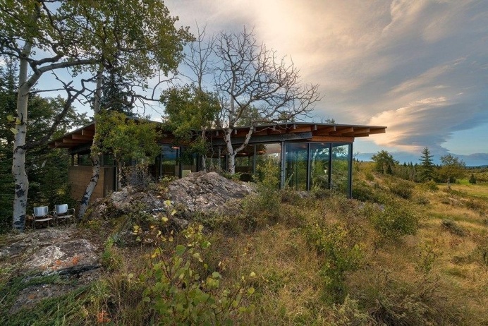 One-Bedroom Cabin Nestled Between Two Massive Lichen-Covered Rocks