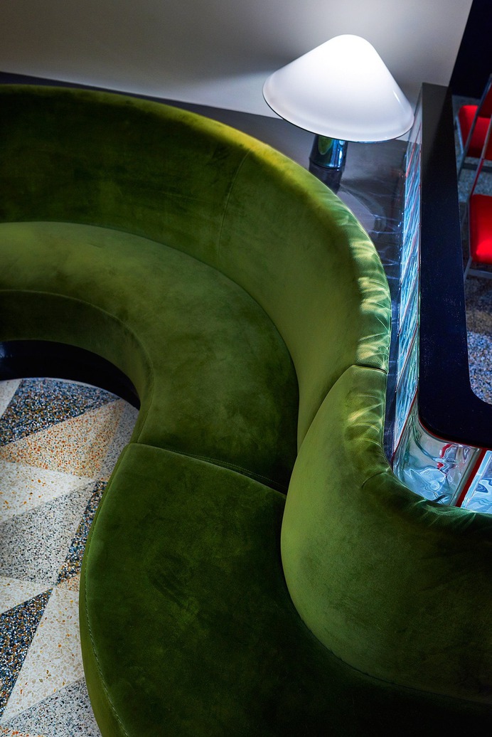 Curved banquettes are upholstered in cotton velvet from New York company F. Schumacher.