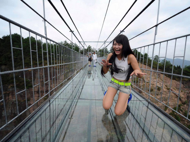 High-altitude suspension bridge made of glass opens in Hunan, China