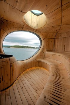 #architecture : Partisans' lakeside sauna takes the form of a cavernous wooden grotto