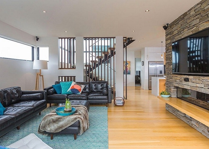 Stylish Contemporary Home with Living Spaces Separated by a Schist Stone Wall 4