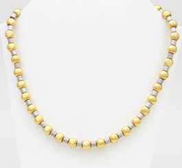 Necklace yellow gold / 18 K white gold with small diamonds in the front part.