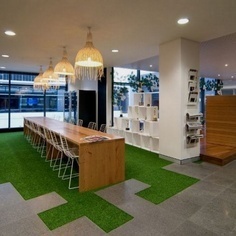 Junction of ict and breakout space floor Grass carpet, interesting board meeting desk. Love the plants around the outside as well! #grass