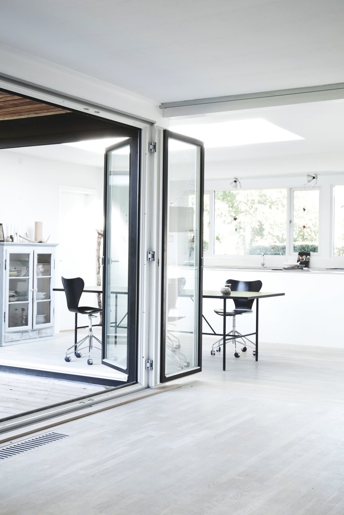 Hallway and dining area with bifold doors. Bang House by Norm.Architects. #normarchitects #door