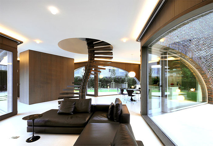 Symmetrical Tripartite Villa Moerkensheide three large arched windows ground floor #interior #sofa #design #living #stairs #room