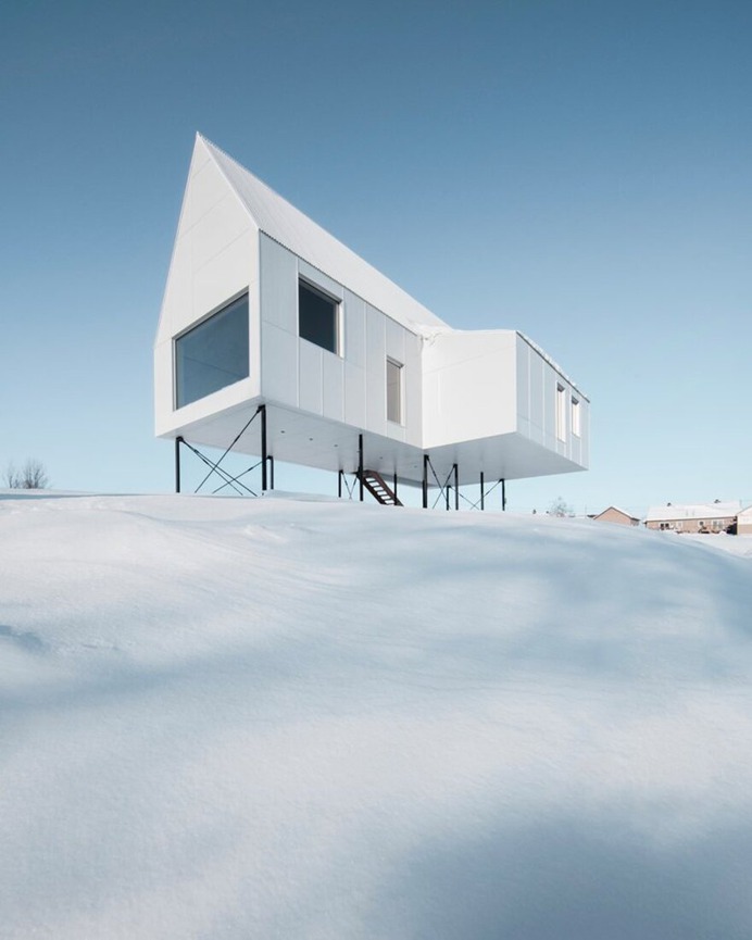 Winter Chalet on Stilts Rises Above a Snow-Laden Slope in Quebec