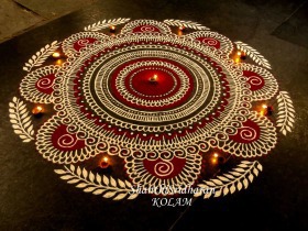 Red and white colored rangoli design
