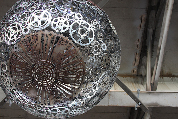 Recycled Bike Part Chandeliers Under a Texas Overpass #silver #chandelier #color #light