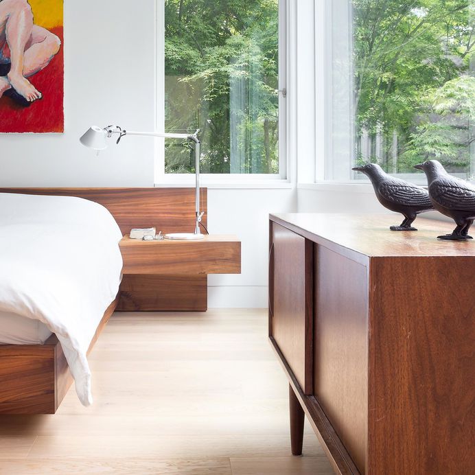 Custom platform bed by Christian Woo lies perfectly beneath the bedroom windows. Tagged: Bedroom, Bed, Table Lighting, Dresser, and Light Hardwood Floor. Photo 38 of 48 in Best Bedroom Bed Dresser Photos from Custom Millwork and Bright Interiors Star in an Elegant Vancouver Home
