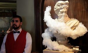 A bust wreathed in clouds of gas from a tear gas canister.