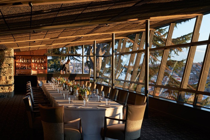 long table inside of room with large glass windows