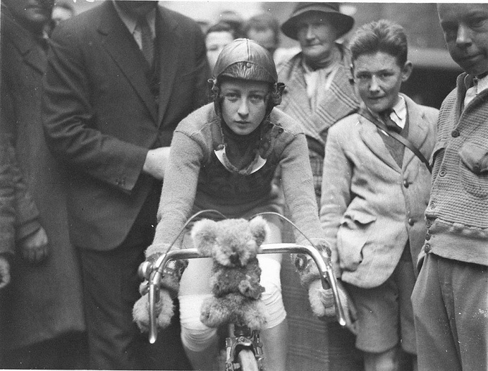 Close-up of Billie Samuel on the Malvern Star bike showing her koala bear mascot before leaving for Melbourne, 4 July 1934, by Sam Hood | Fl #white #koala #bicycle #of #samuel #july #black #4th #bike #and #billie