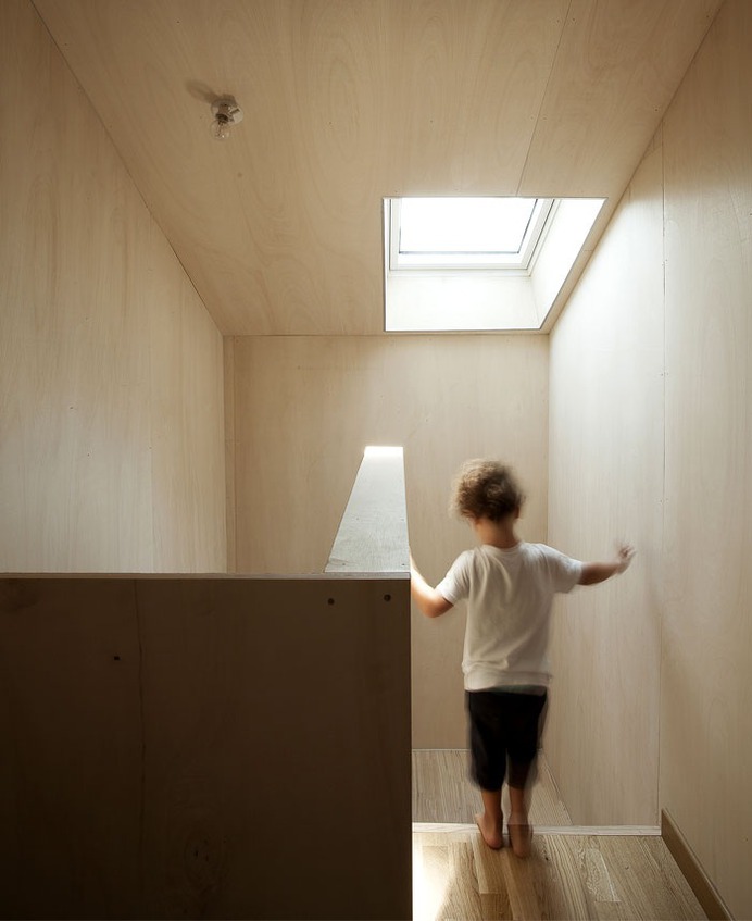 Beach Cottage Covered by a Dark Wood Cladding - InteriorZine