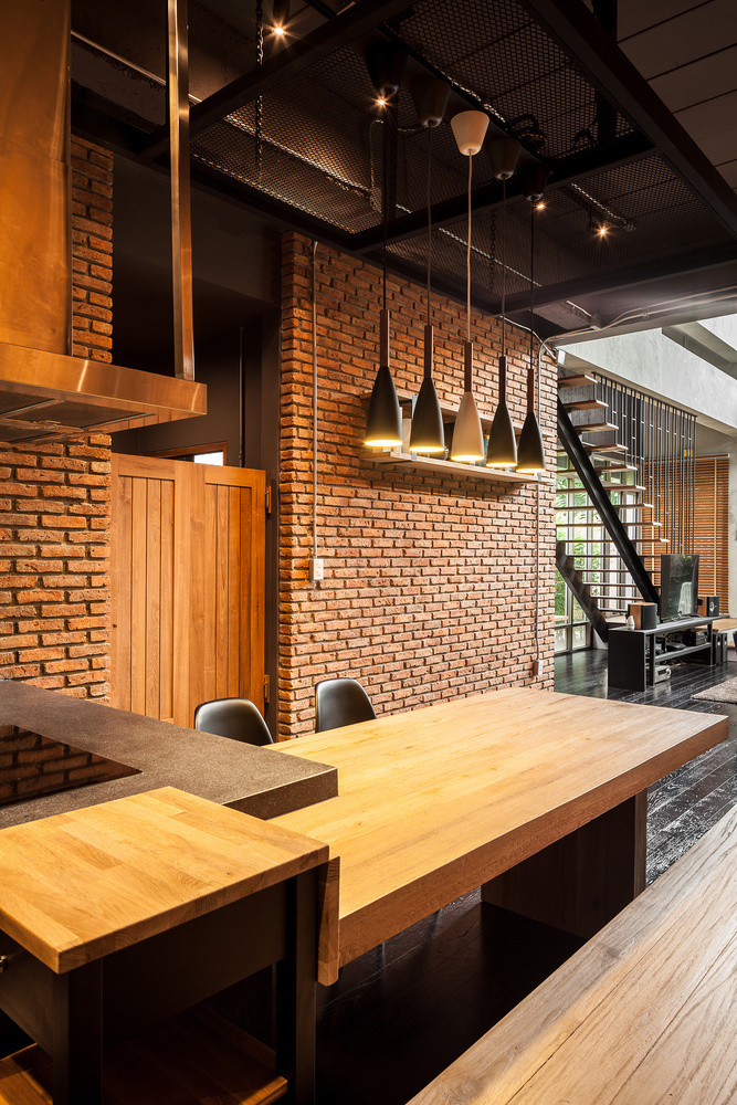 Two Houses Connected to Each Other for Two Brothers with Different Lifestyles