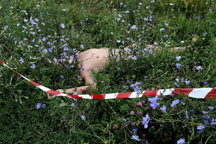 The body of one of the passengers lays near the crash site of the MH17, Malaysia Airlines flight, which crashed while flying over Donetsk