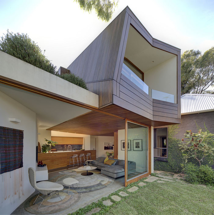 Cottage With a Series of Indoor and Outdoor Spaces