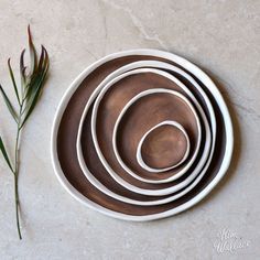 Kim wallace - Handmade ceramic pebble plate, made from white porcelain clay and hand-brushed with a stunning rust coloured glaze. Each piece is shaped and glazed entirely by hand, creating a gorgeous organic feel with no two pieces exactly the same. This unique glaze has a satin finish with gorgeous tactile feel. The edges of and base of the pieces are left unglazed, creating a stunning contrast and a vitrified surface with a tactile feel. Backorders If these pieces are not in stock we ca...