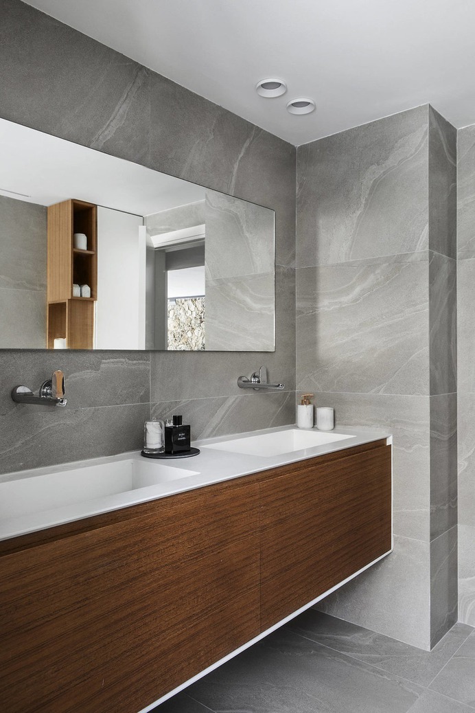 Large grey stone wall & Floor tile with wood cabinetry – for Bathroom