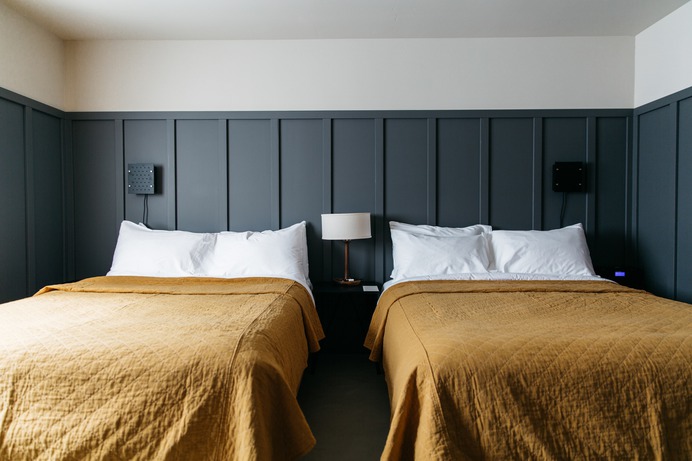 bedroom-yellow-blankets-gray-walls-coachman