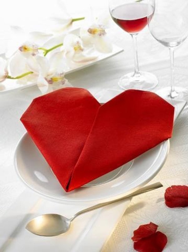 A red heart shaped napkin folding for Valentine's Day