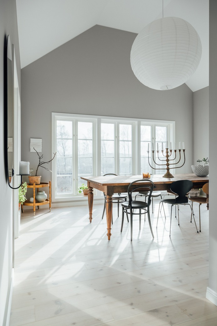The wide-planked pine flooring extends into the dining room, just off the kitchen.