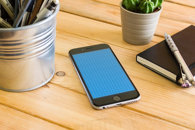 Free Realistic iPhone 6 Mockup on Wooden Table
