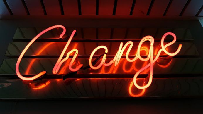 A glowing red "change" neon on a wall