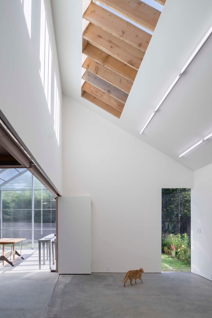Spacious #workspace with #highceiling. #HeSheAndIt by #DavidsonRafailidis. Photo by #FlorianHolzherr. #concretefloor #roofwindow