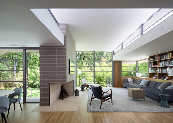 Living Room, Accent Lighting, Sectional, Bookcase, Chair, Ottomans, Corner Fireplace, End Tables, Recessed Lighting, and Light Hardwood Floor Photo 1 of 19 in Inwood Place by Tim Cuppett Architects