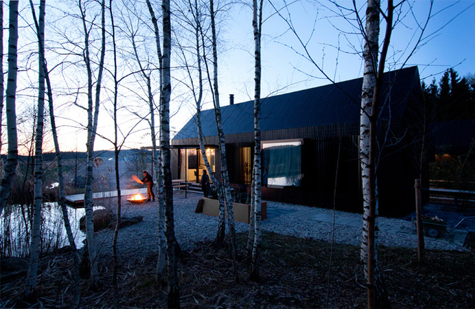 format elf nestles dark barn-shaped houses into bavarian forest #home
